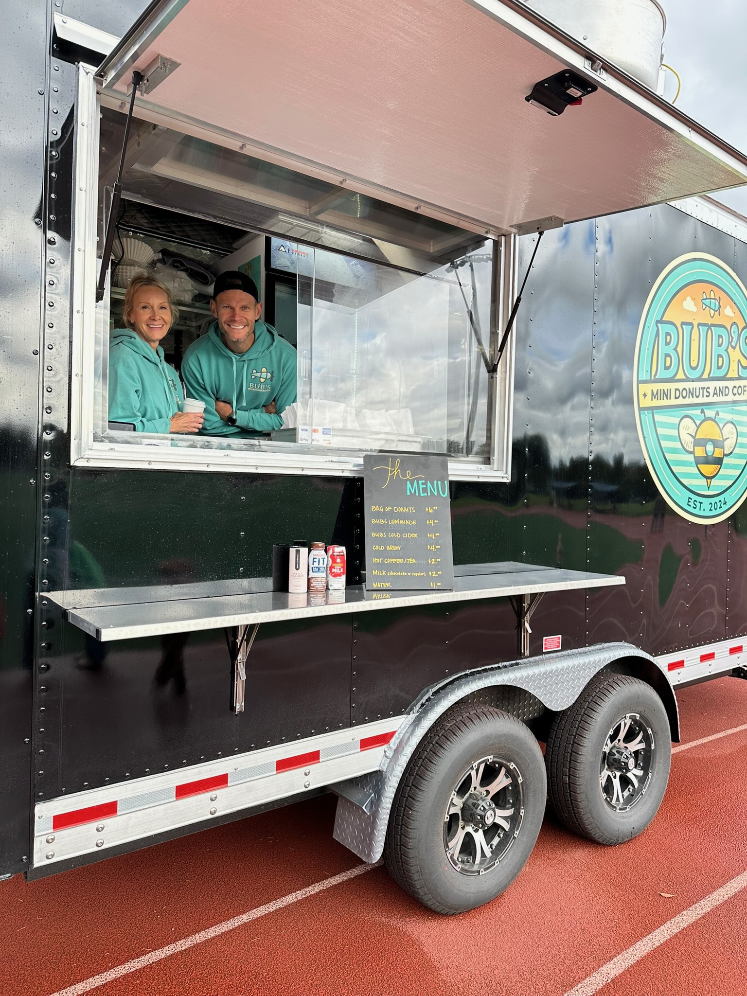Two Bub's team members welcoming guests from the trailer