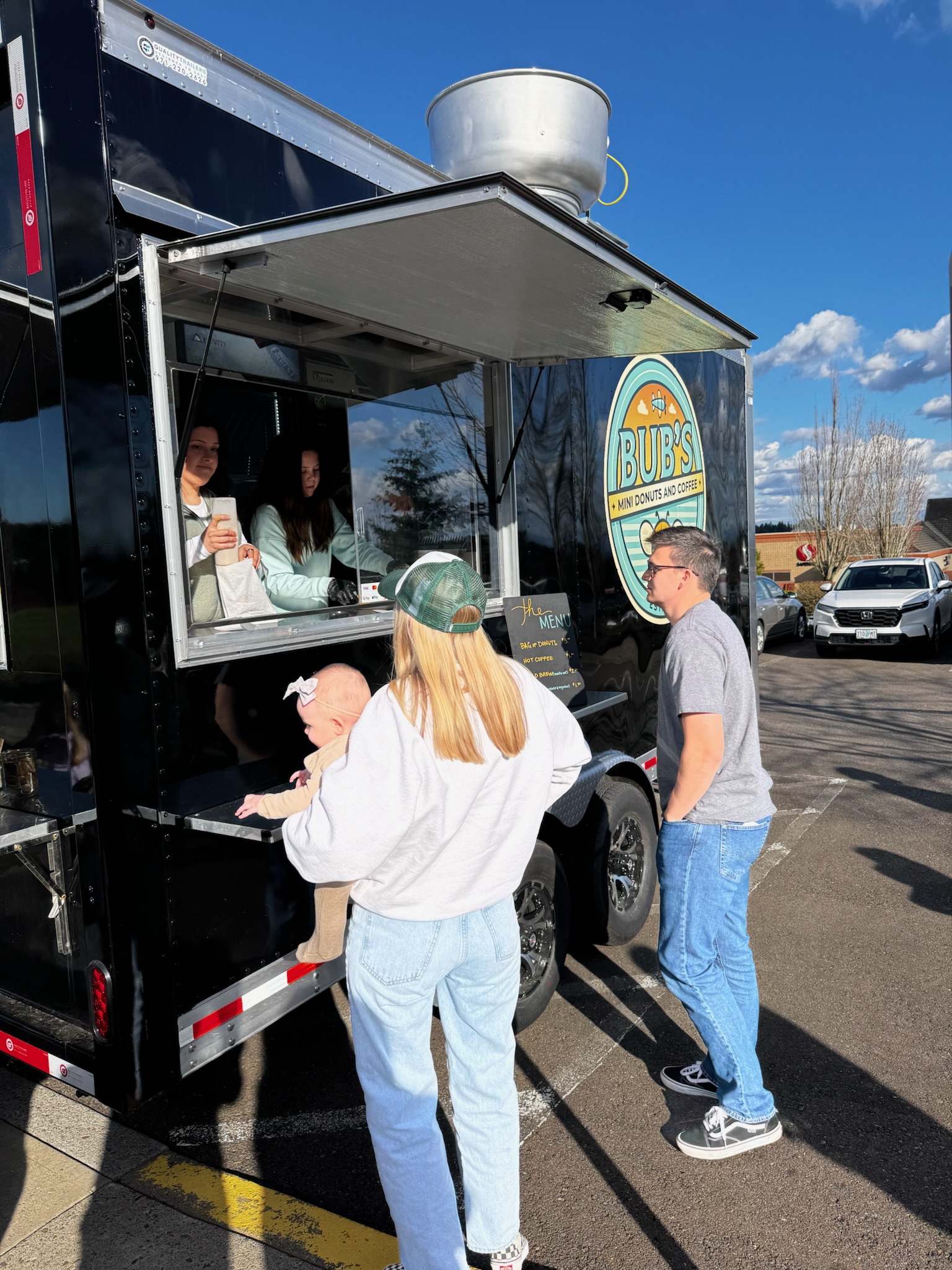 Guests ordering donuts and drinks at the Bub's trailer