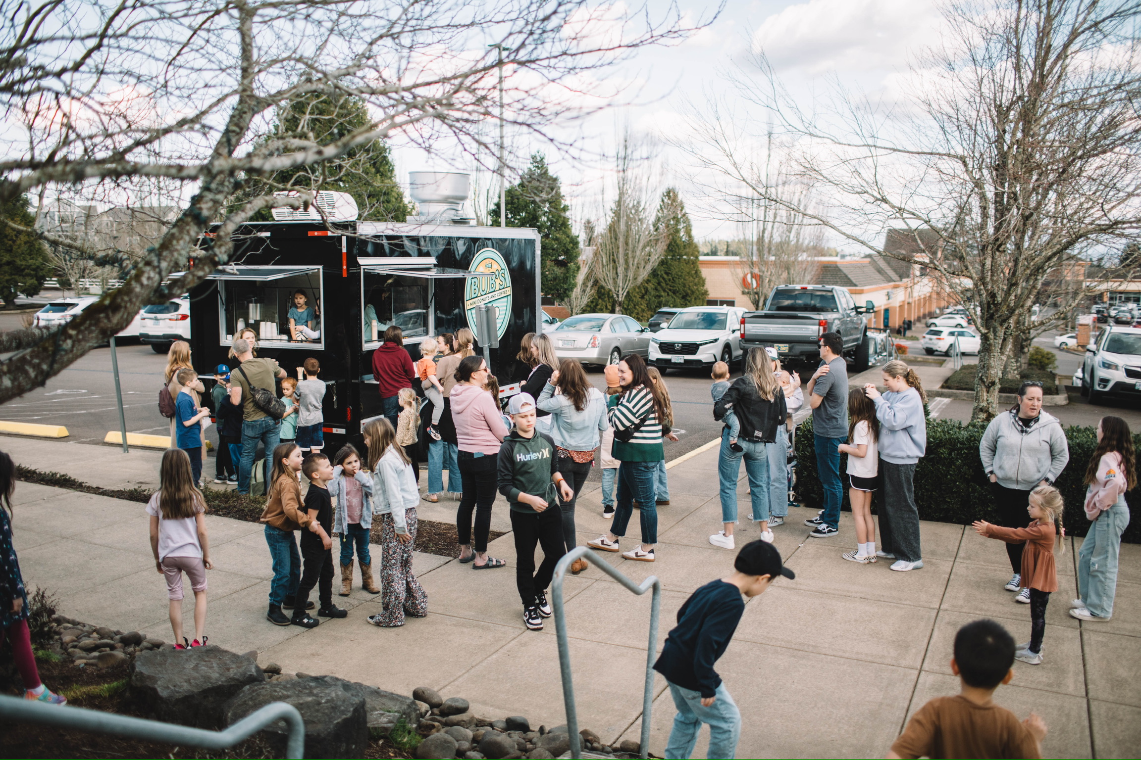 A community crowd enjoying an event around the Bub's trailer