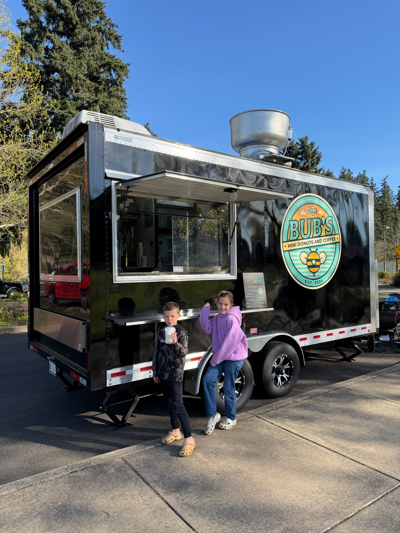 Two young guests standing proudly in front of the Bub's trailer