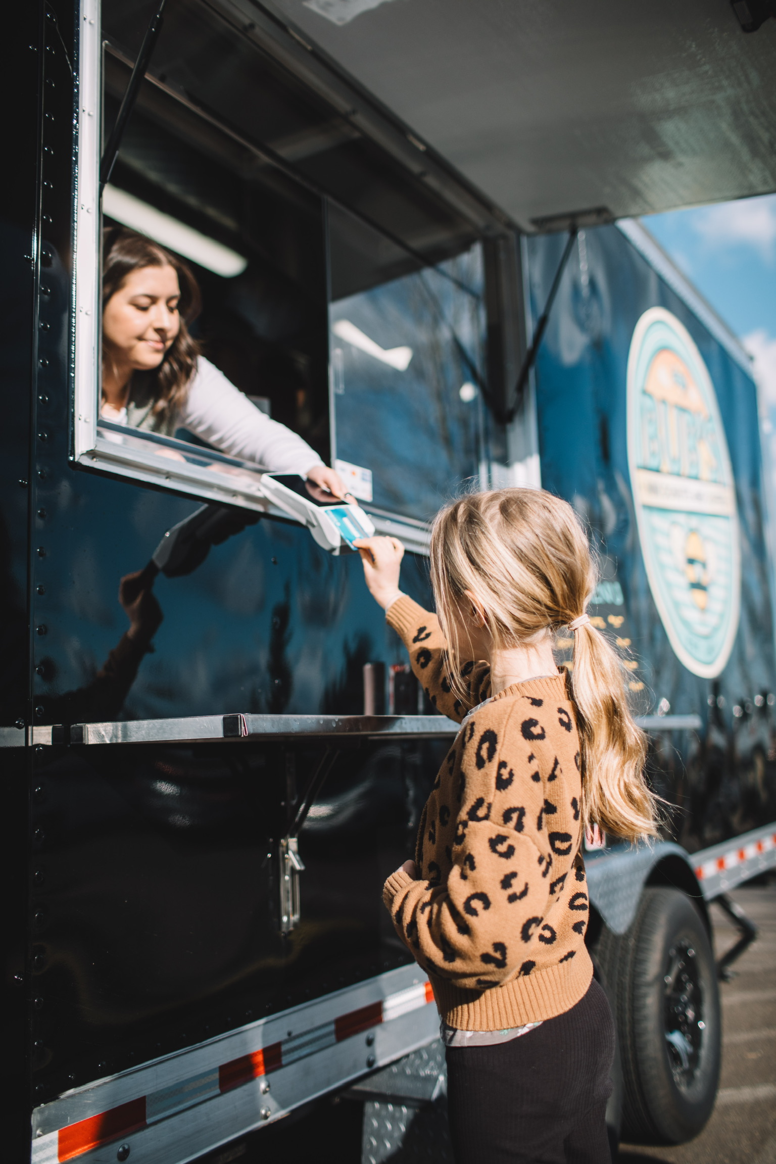 A young guest paying at the Bub's trailer window