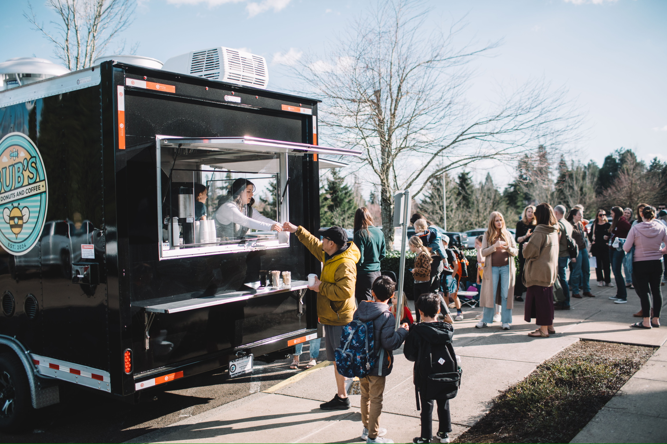 The Bub's team serving guests from the trailer at a community event